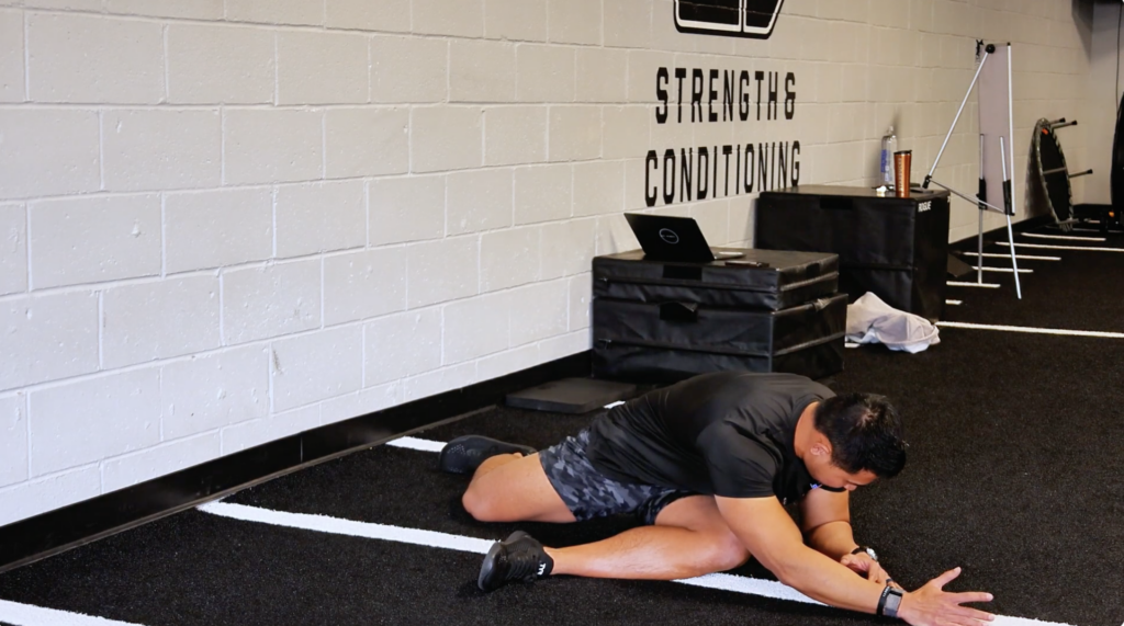 physical therapist showing hip stretch to protect ACL